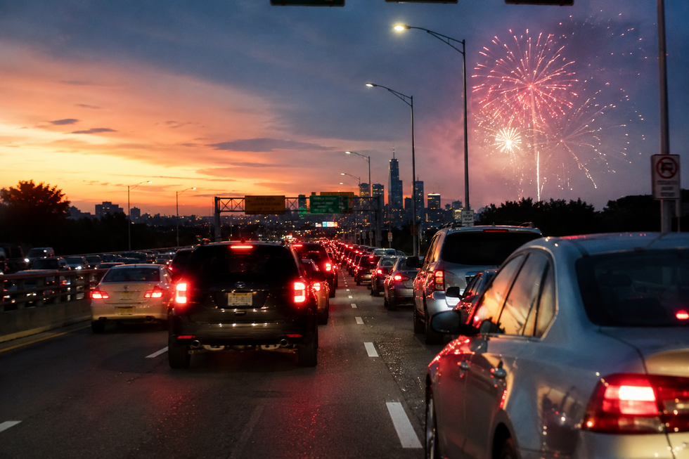Heavy Fourth of July holiday traffic on a New Jersey highway during an extreme heat wave at sunset, illustrating conditions that can increase the risk of car accidents.