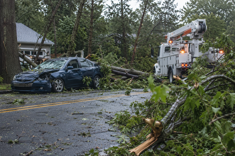 Storm damage blocking a New Jersey roadway after tornadoes, illustrating hazardous conditions that can lead to serious car accidents and workplace injuries.