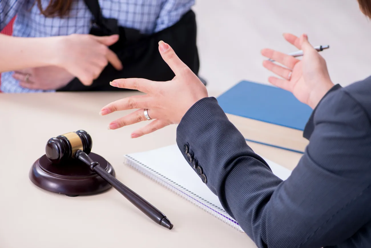 Attorney discussing a legal matter with a client wearing an arm sling