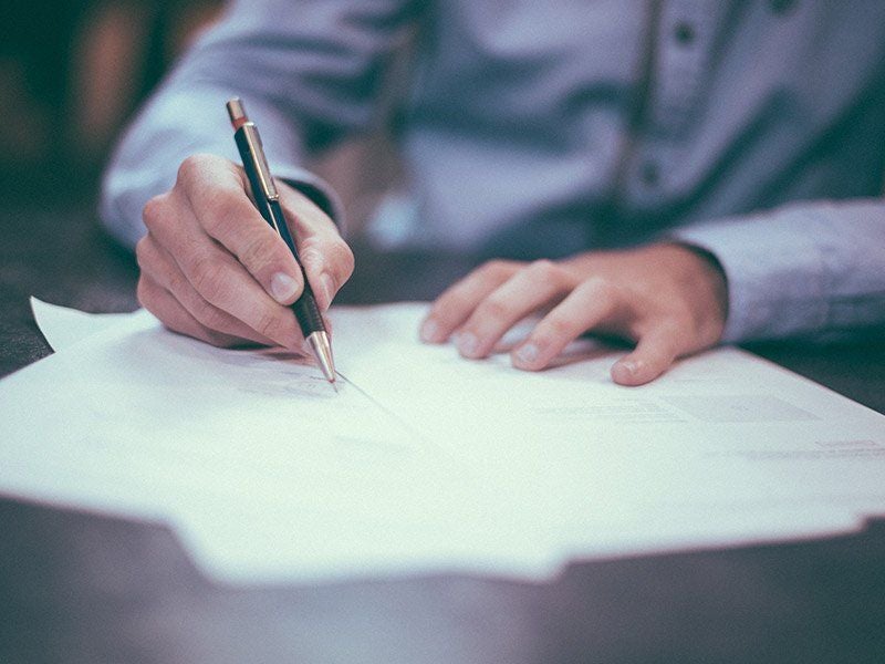 attorney sigining a paper