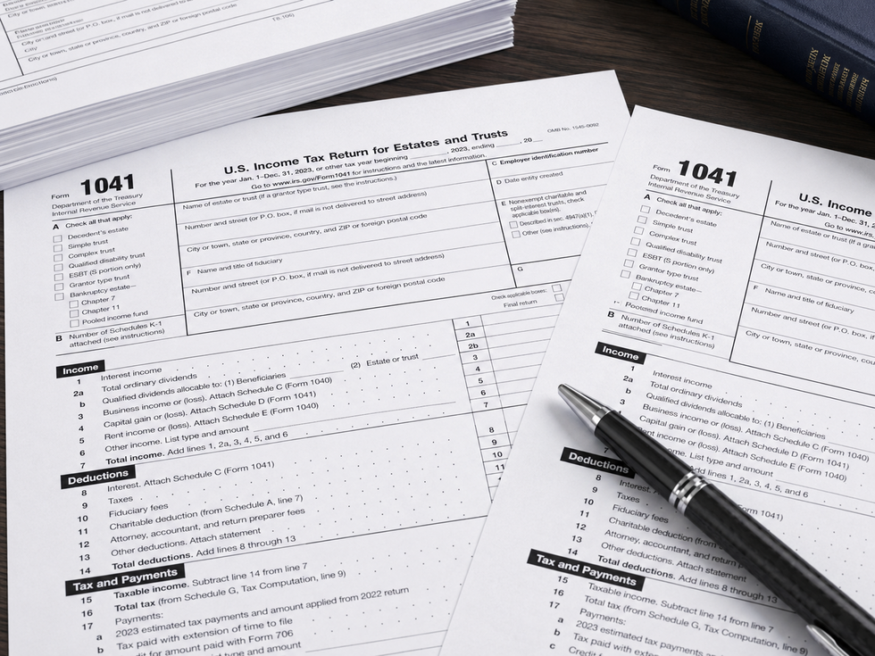 Close up of IRS Form 1041 tax documents, used for U.S. Income tax returns for estates and trusts, spread across a desk.