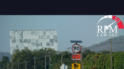 White car driving through a speed monitoring zone