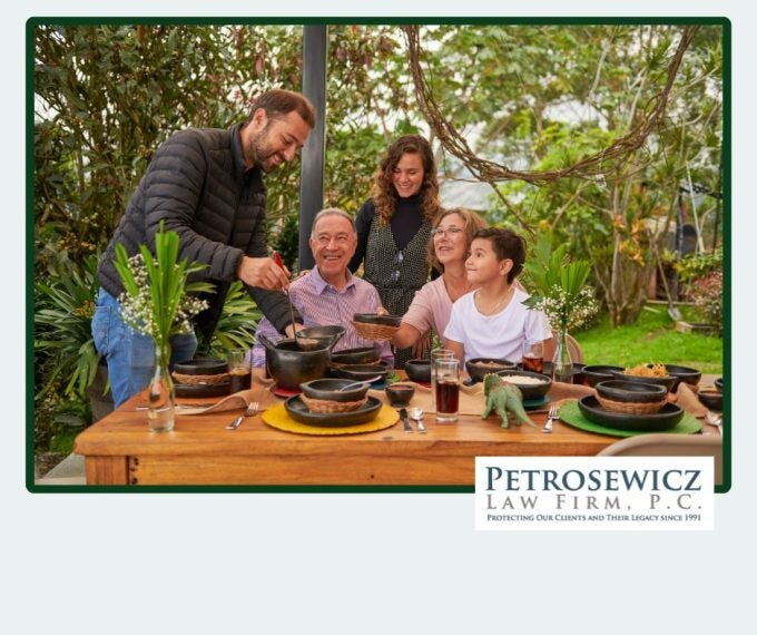 Multigenerational Family smiling over a table of food.