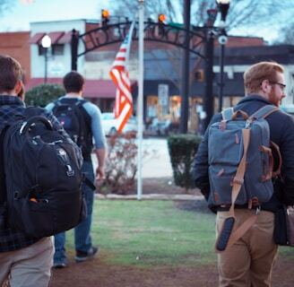 men walking towards flag on pole