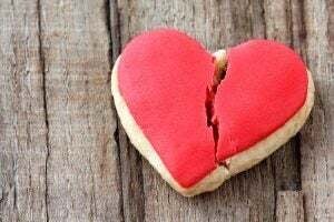 Cracked heart shaped cookie decorated with red icing