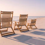 Three beach chairs in descending sizes on a Fort Myers Beach shoreline at sunrise, representing estate planning for grandchildren across three generations