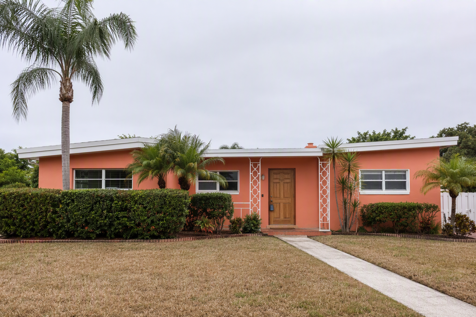 Punta Gorda, Florida block home with a real estate lockbox on the door, representing a house being sold during probate.