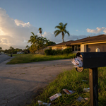 Overflowing mailbox outside a closed-up Lehigh Acres, Florida home, representing an estate nobody has opened.