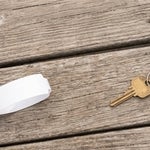 Hospital wristband and a house key on a Southwest Florida dock, representing medical and property decisions