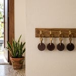 Key rack inside a Cape Coral home with four house keys and one empty hook, representing heirs who must all sign to sell inherited property in Florida