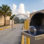Empty pneumatic carrier at a Lehigh Acres bank drive-up lane, representing a deceased person’s bank account in Florida waiting to be released