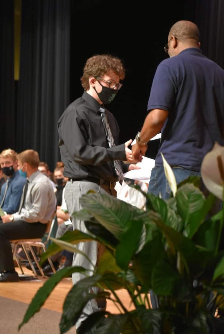 mark nicholson handing a Nicholson Scholarship to Grayson Joslin