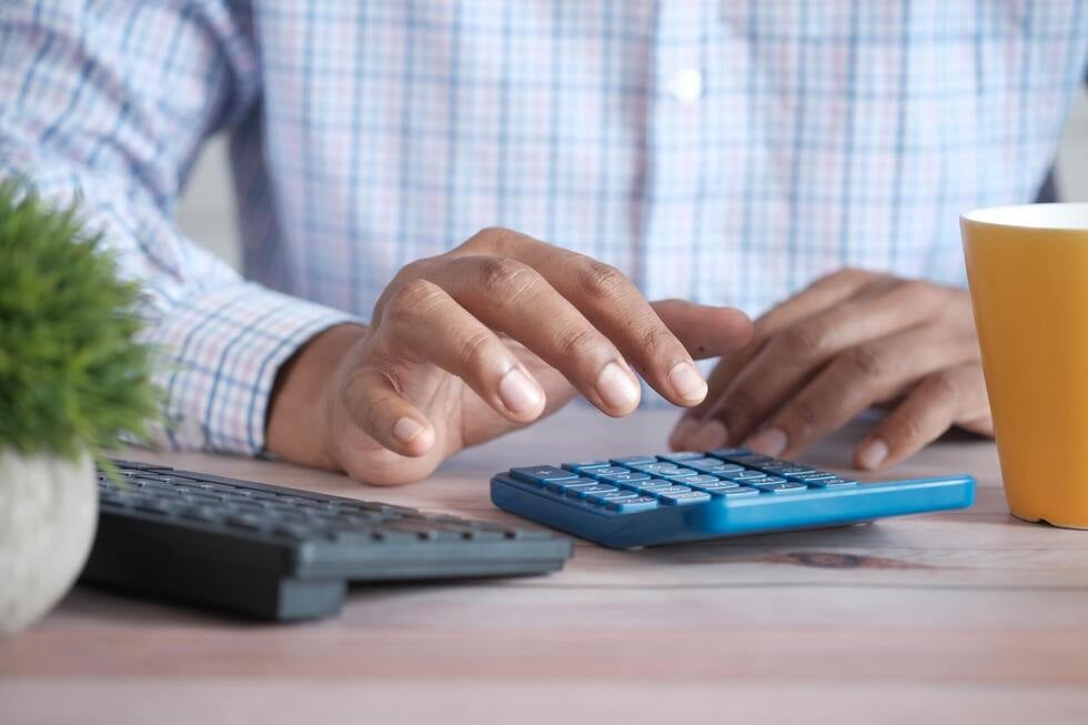 A man using a calculator to determine jail time credit