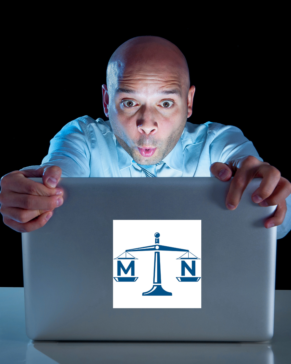 Man looking at computer in a darkened room in Indianapolis