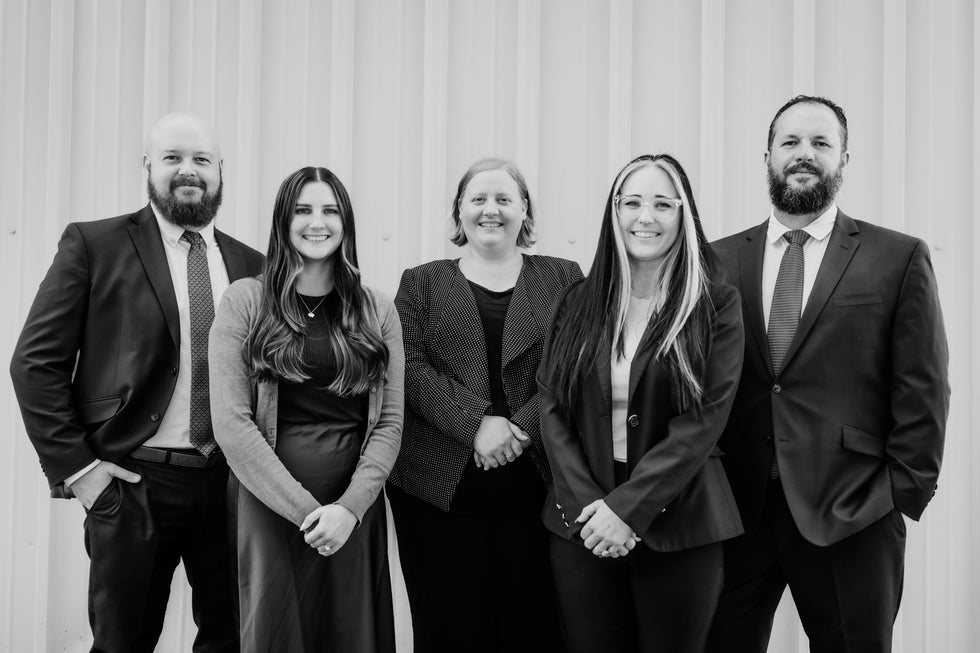 Group photo of the Higher Level Legal team in Raymore, Missouri, including attorneys and staff who handle family law, divorce, custody, and criminal defense cases
