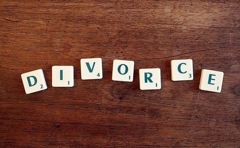 Scrabble tiles laid out on a table to spell divorce.