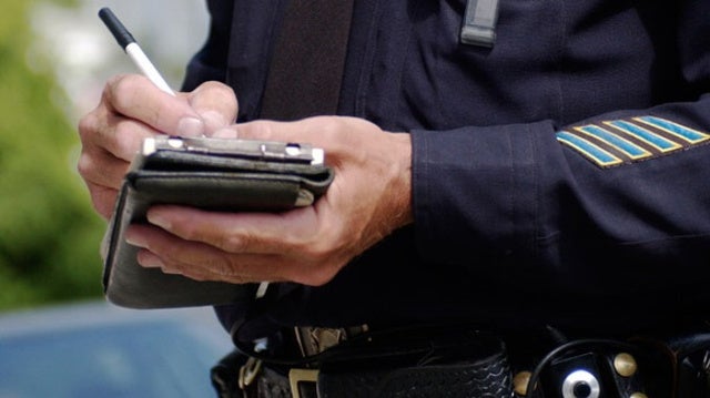 Police officer writing a traffic ticket