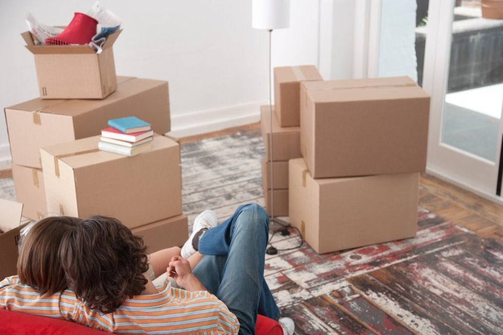 Man and woman in a relationship sitting next to moving boxes