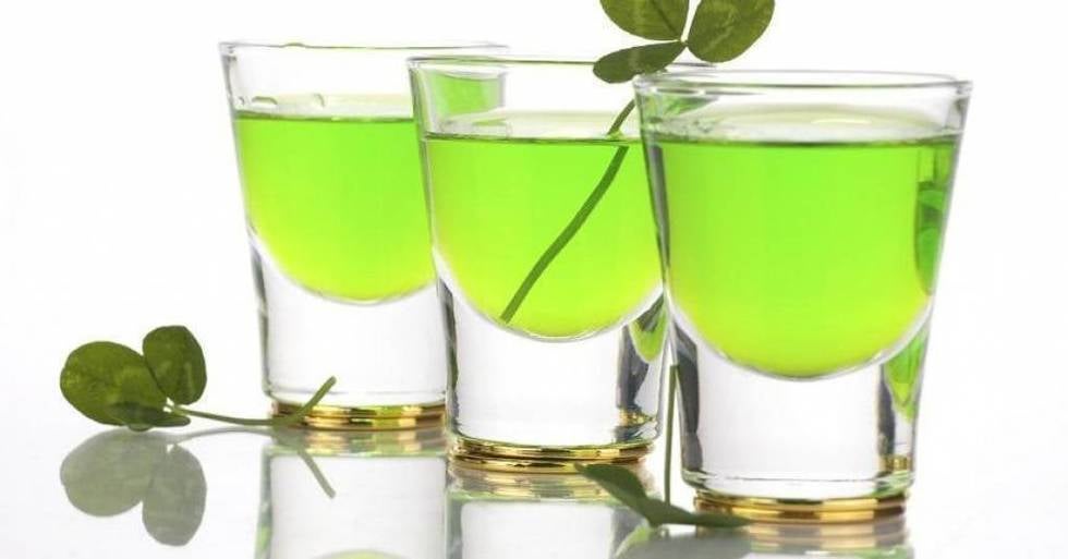 Festive green shots of alcohol with clovers for St. Patrick's Day