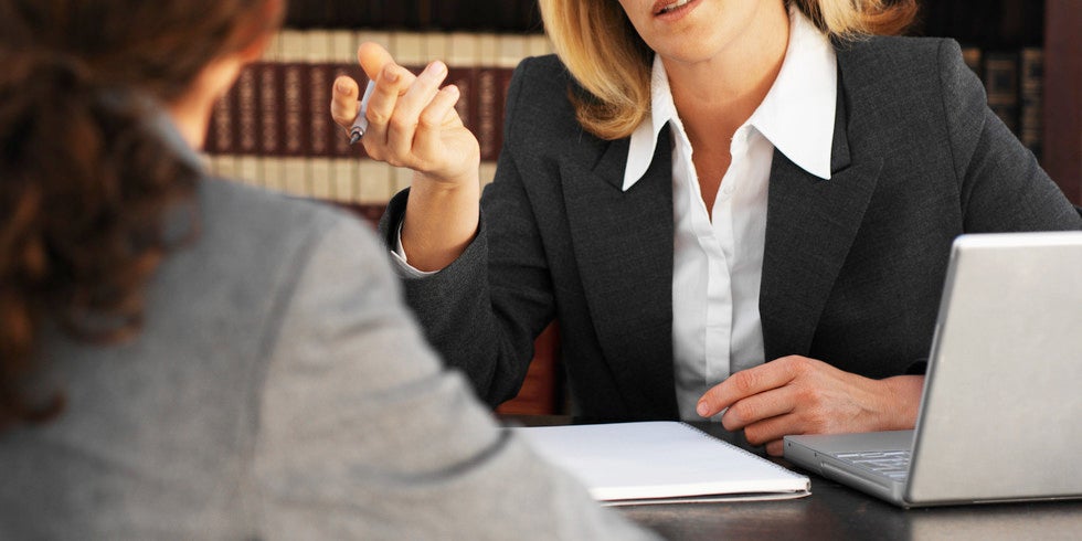 Woman meeting with a lawyer in an office.